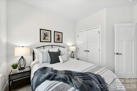a bedroom with a bed and a lamp