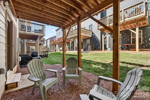 a view of a chairs and table in backyard of the house