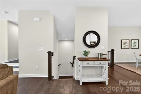 a living room with furniture and a mirror