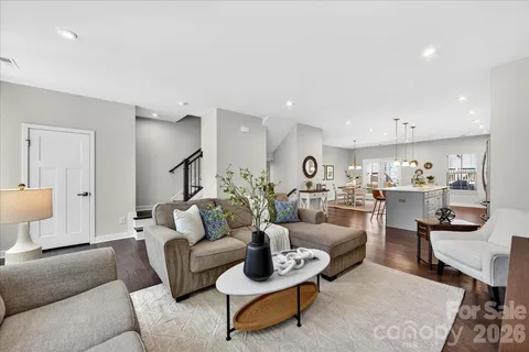 a living room with furniture and view of kitchen