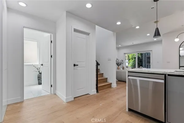 a view of kitchen with stainless steel appliances granite countertop cabinets and window