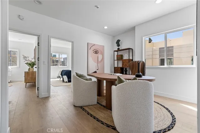 a living room with furniture a window and a wooden floor