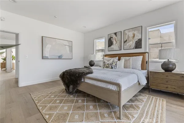 a bedroom with a bed and painting on the wall