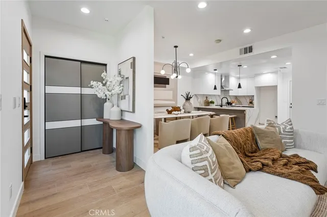 a living room with furniture and a kitchen