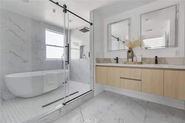 a bathroom with a tub sink and mirror