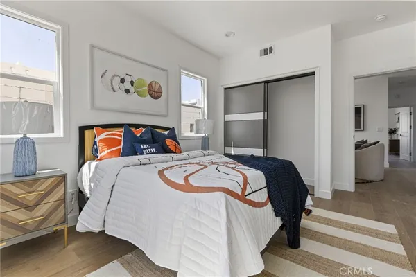 a bedroom with a bed and painting on the wall