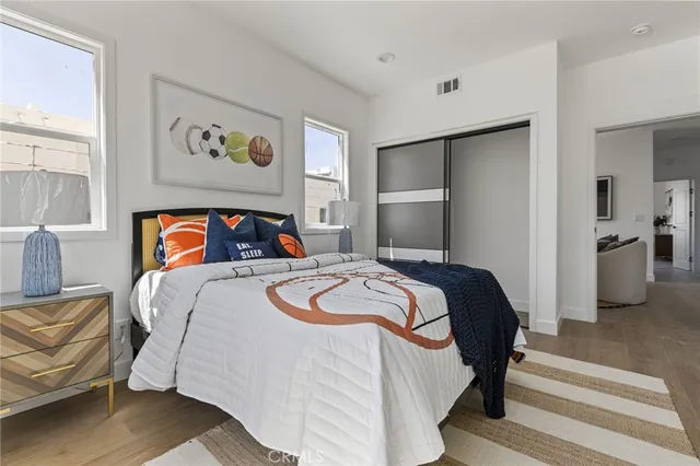 a bedroom with a bed and painting on the wall