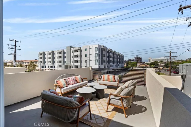 a living room with furniture and a kitchen view