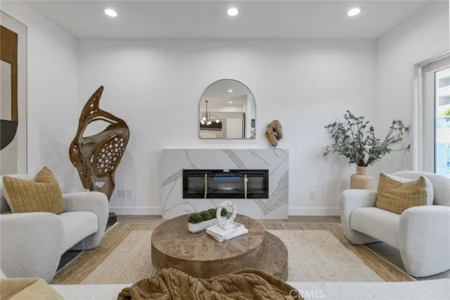 a living room with furniture fireplace and a fireplace