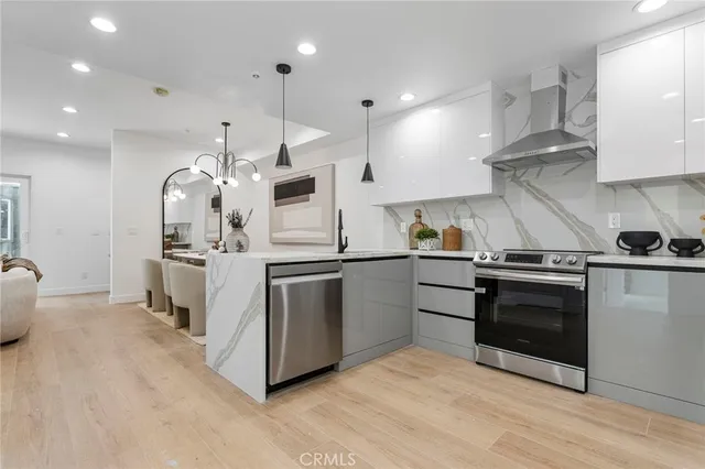 a kitchen with stainless steel appliances kitchen island granite countertop a stove and a sink