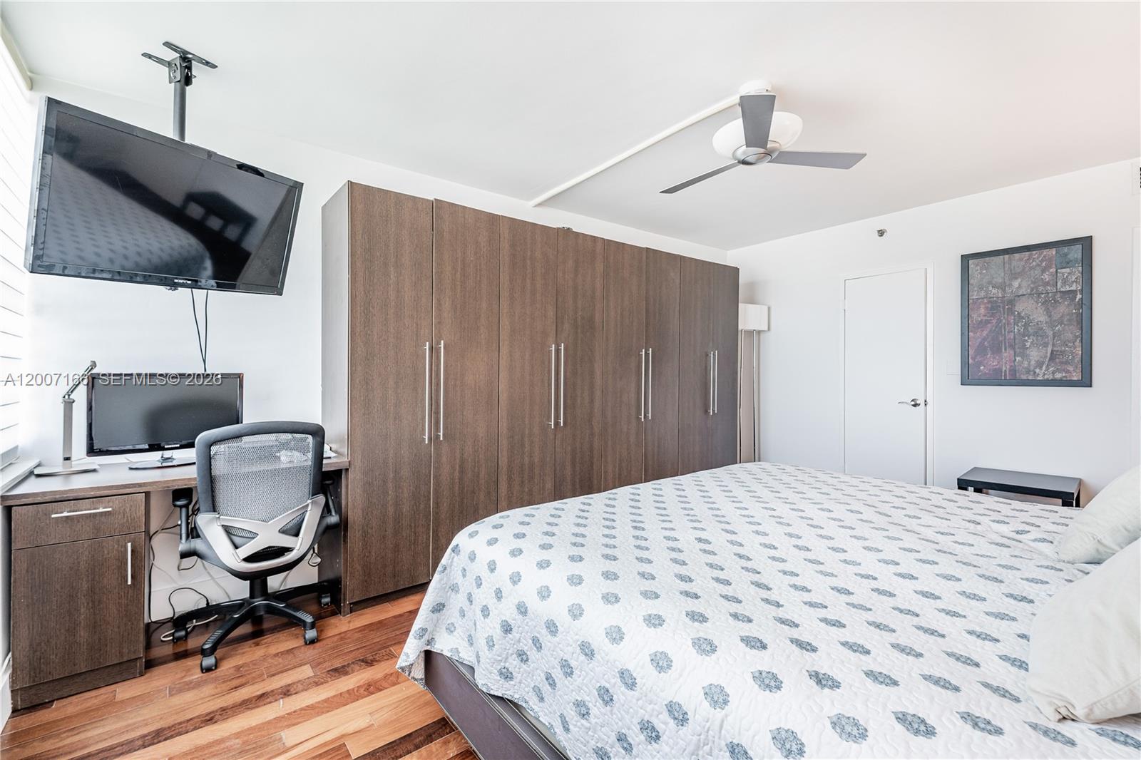 100 Lincoln Road, Unit 944 Miami Beach, FL 33139 - Photo 14 of 40 a bedroom with a bed a computer on the desk and a chair