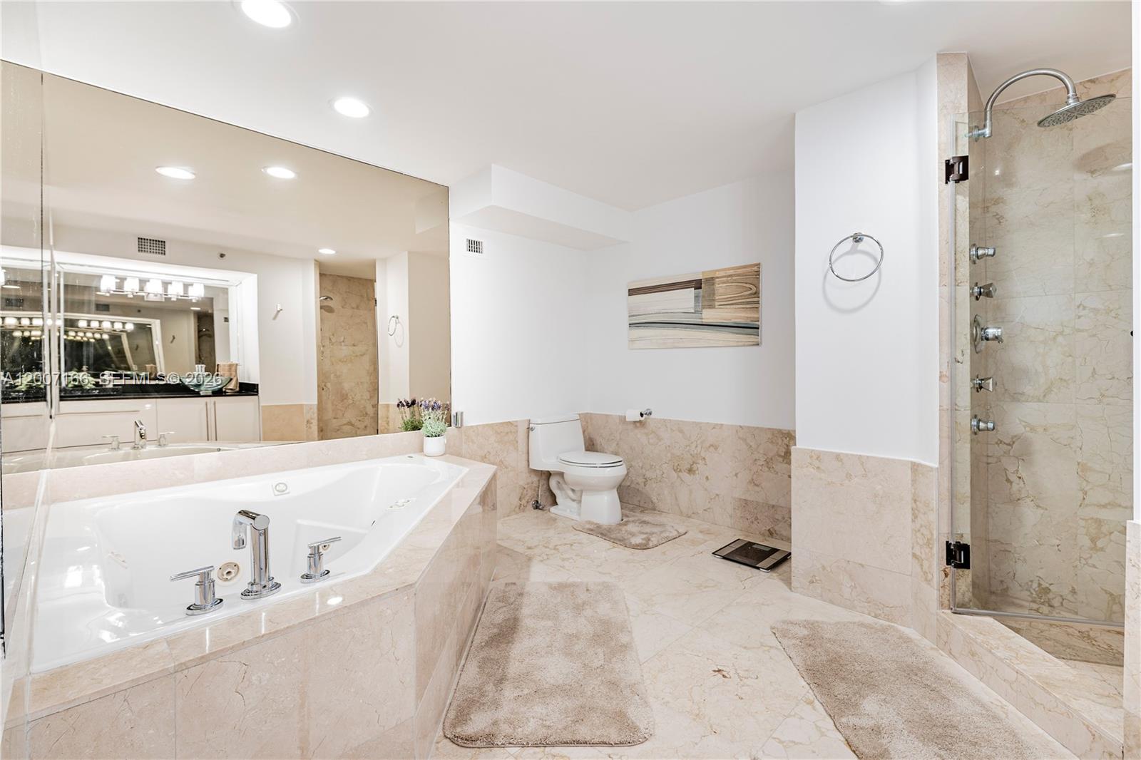 100 Lincoln Road, Unit 944 Miami Beach, FL 33139 - Photo 16 of 40 a large bathroom with a tub sink and mirror
