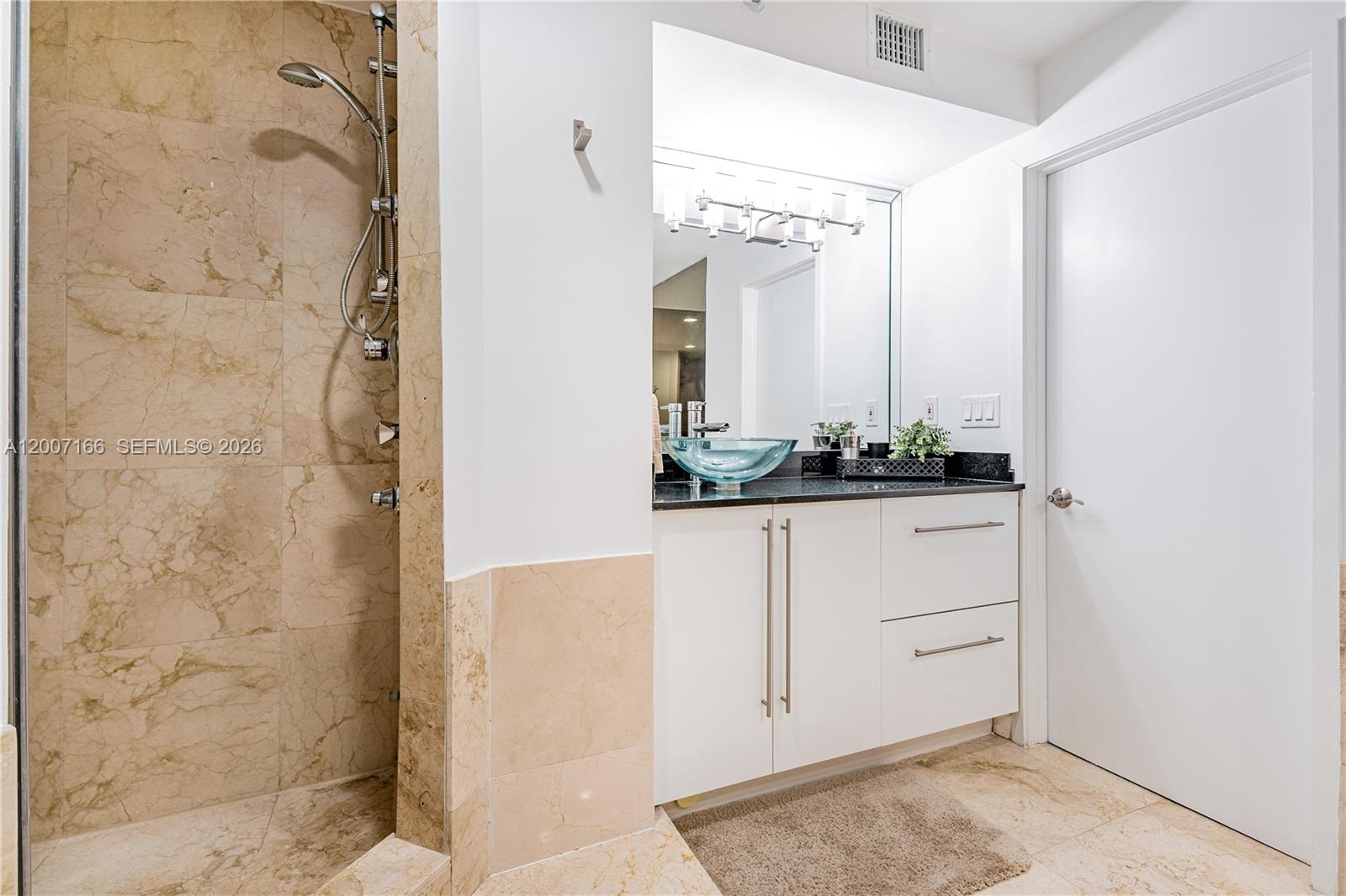 100 Lincoln Road, Unit 944 Miami Beach, FL 33139 - Photo 17 of 40 a bathroom with a shower and a mirror