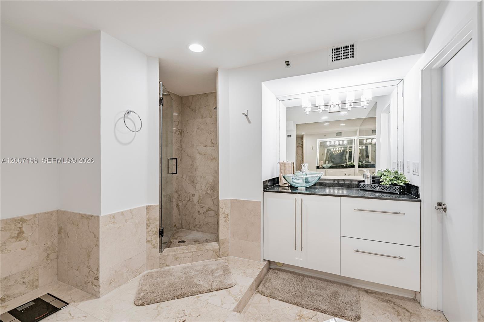 100 Lincoln Road, Unit 944 Miami Beach, FL 33139 - Photo 19 of 40 a bathroom with a granite countertop sink a mirror a vanity and a shower