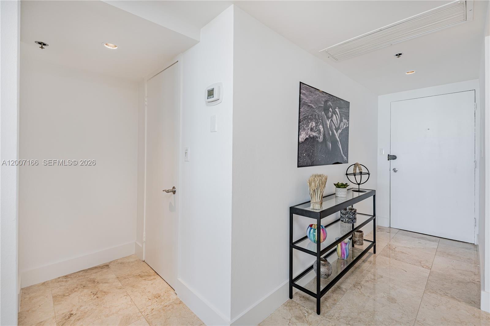 100 Lincoln Road, Unit 944 Miami Beach, FL 33139 - Photo 3 of 40 a view of a hallway with paintings on the wall