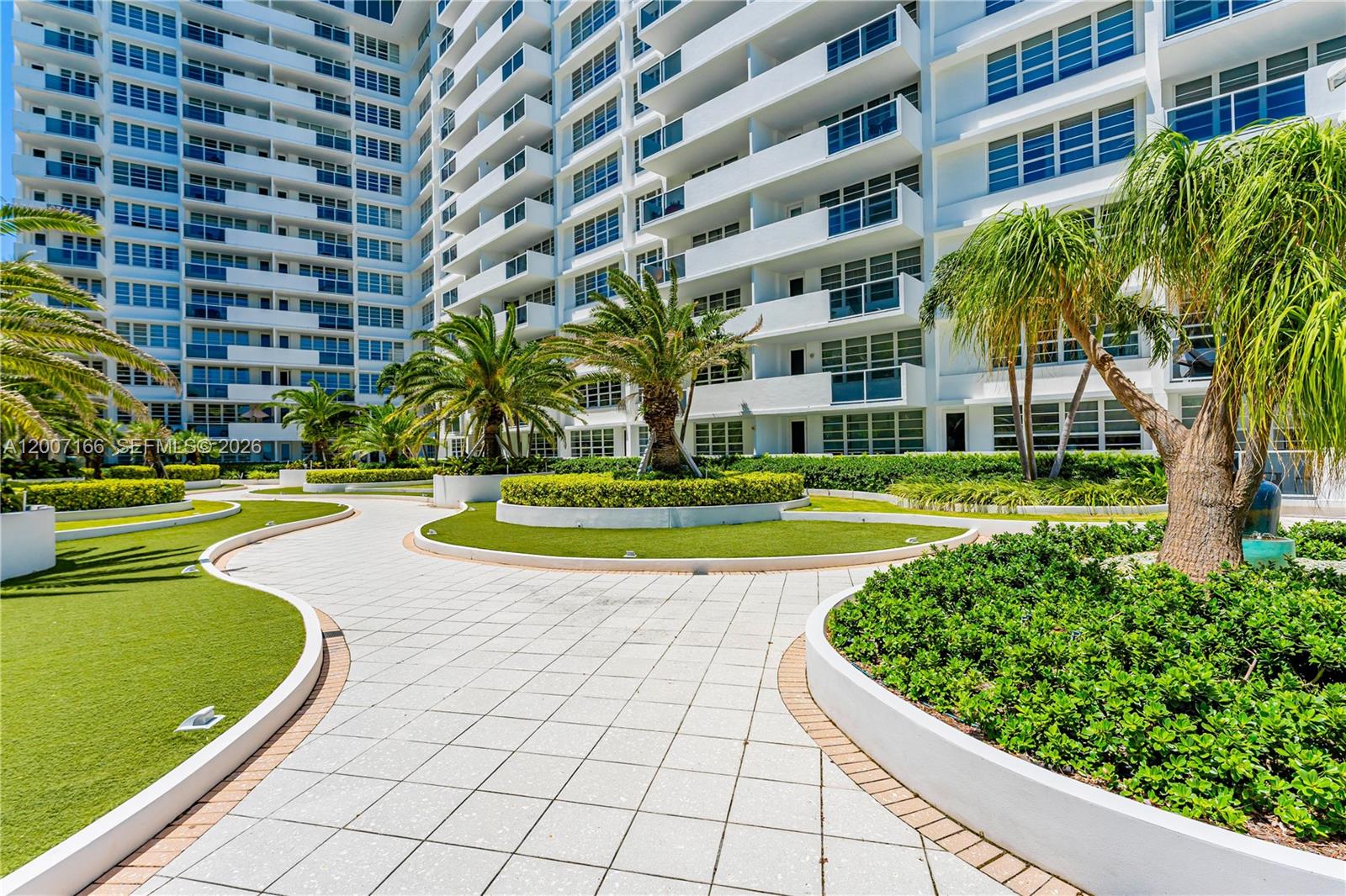 100 Lincoln Road, Unit 944 Miami Beach, FL 33139 - Photo 33 of 40 a view of a swimming pool with a lawn chairs and plants