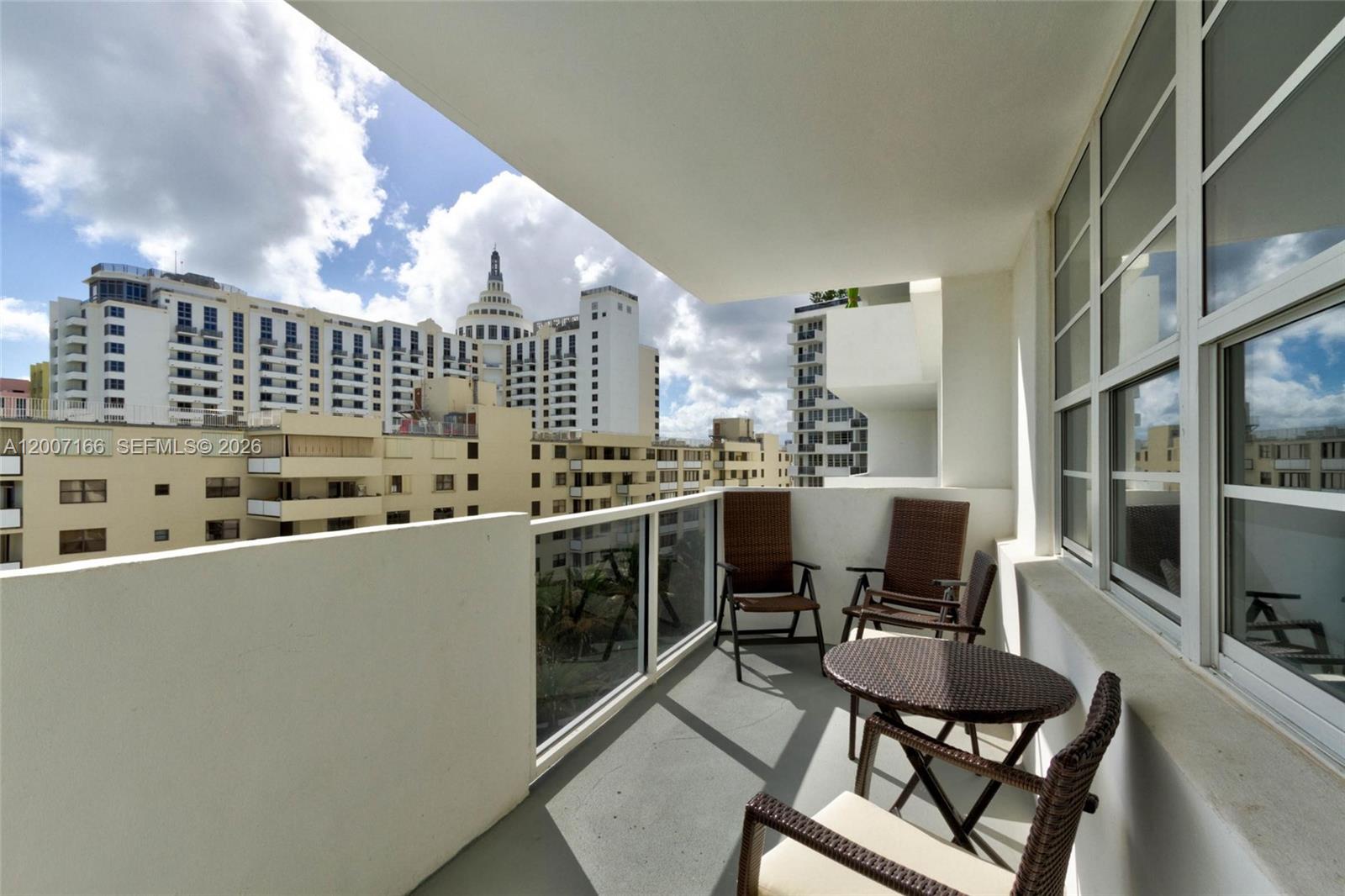 100 Lincoln Road, Unit 944 Miami Beach, FL 33139 - Photo 39 of 40 a kitchen with stainless steel appliances a table and chairs in it