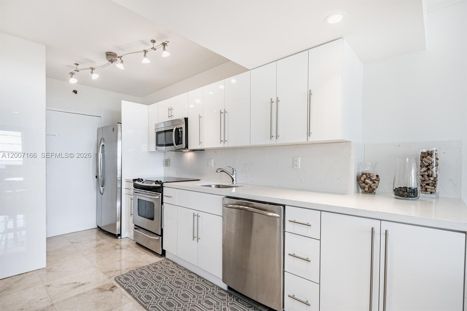 100 Lincoln Road, Unit 944 Miami Beach, FL 33139 - Photo 4 of 40 a kitchen with stainless steel appliances granite countertop a sink a stove a refrigerator and cabinets