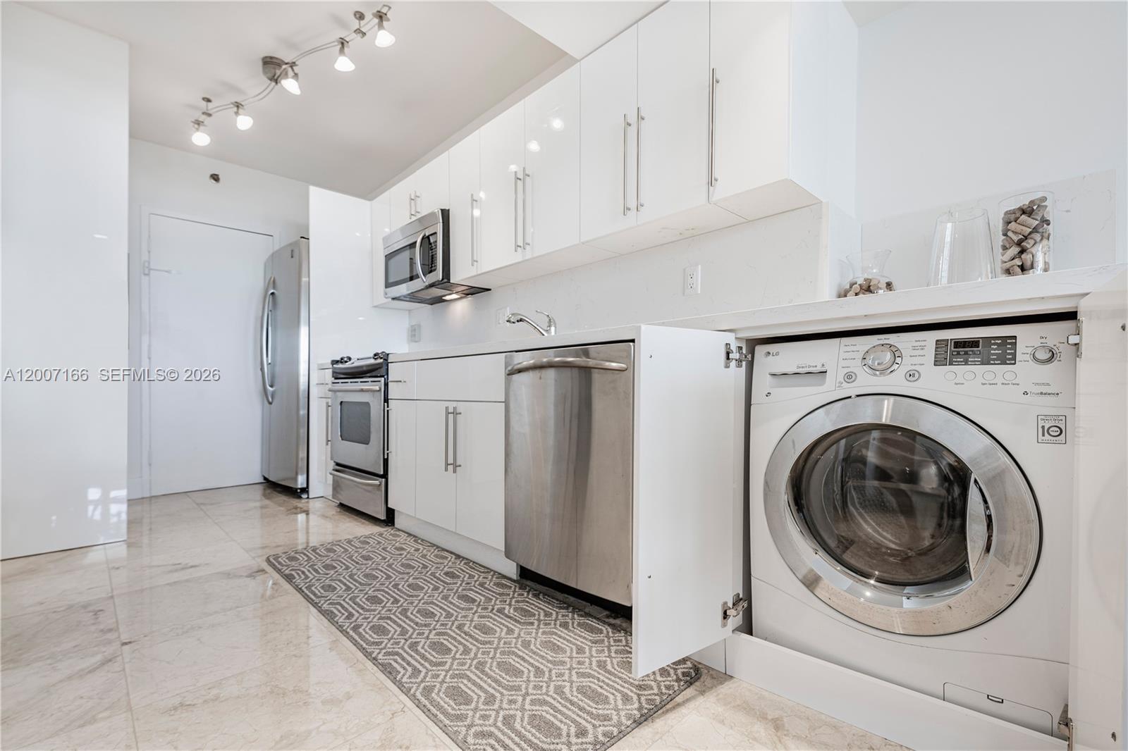100 Lincoln Road, Unit 944 Miami Beach, FL 33139 - Photo 7 of 40 a view of a kitchen with refrigerator and cabinets