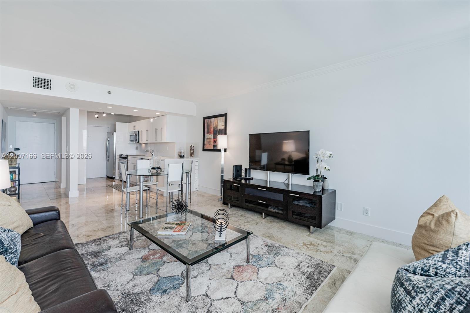 100 Lincoln Road, Unit 944 Miami Beach, FL 33139 - Photo 10 of 40 a living room with furniture and a flat screen tv