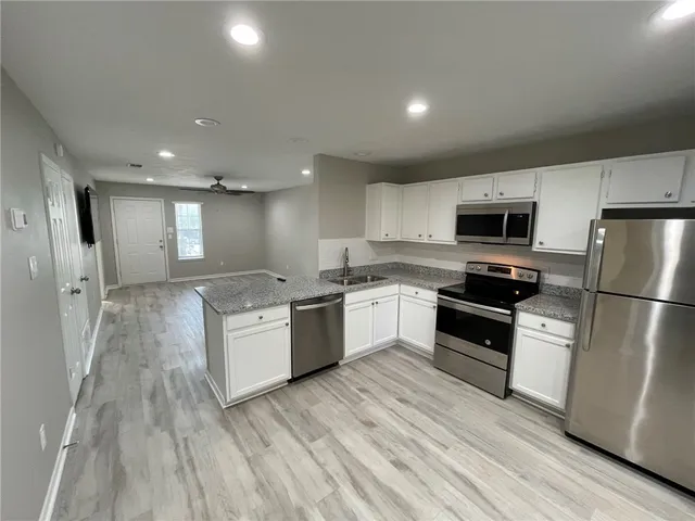 a kitchen with a refrigerator stove and microwave