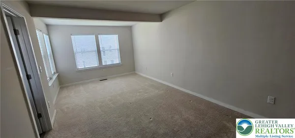 a view of an empty room and a window