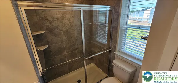 a bathroom with a shower and a sink