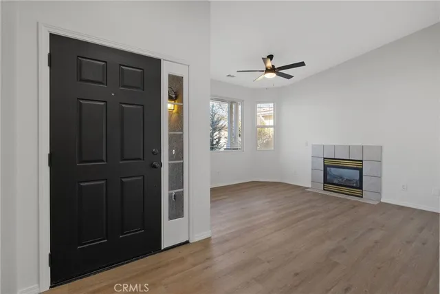 an empty room with windows and cabinet