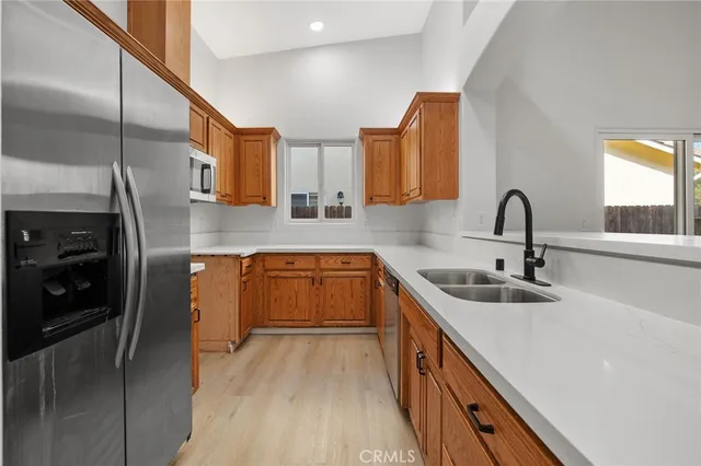 a kitchen with a sink cabinets and stainless steel appliances