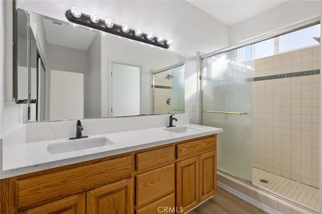 a bathroom with a granite countertop shower sink and toilet