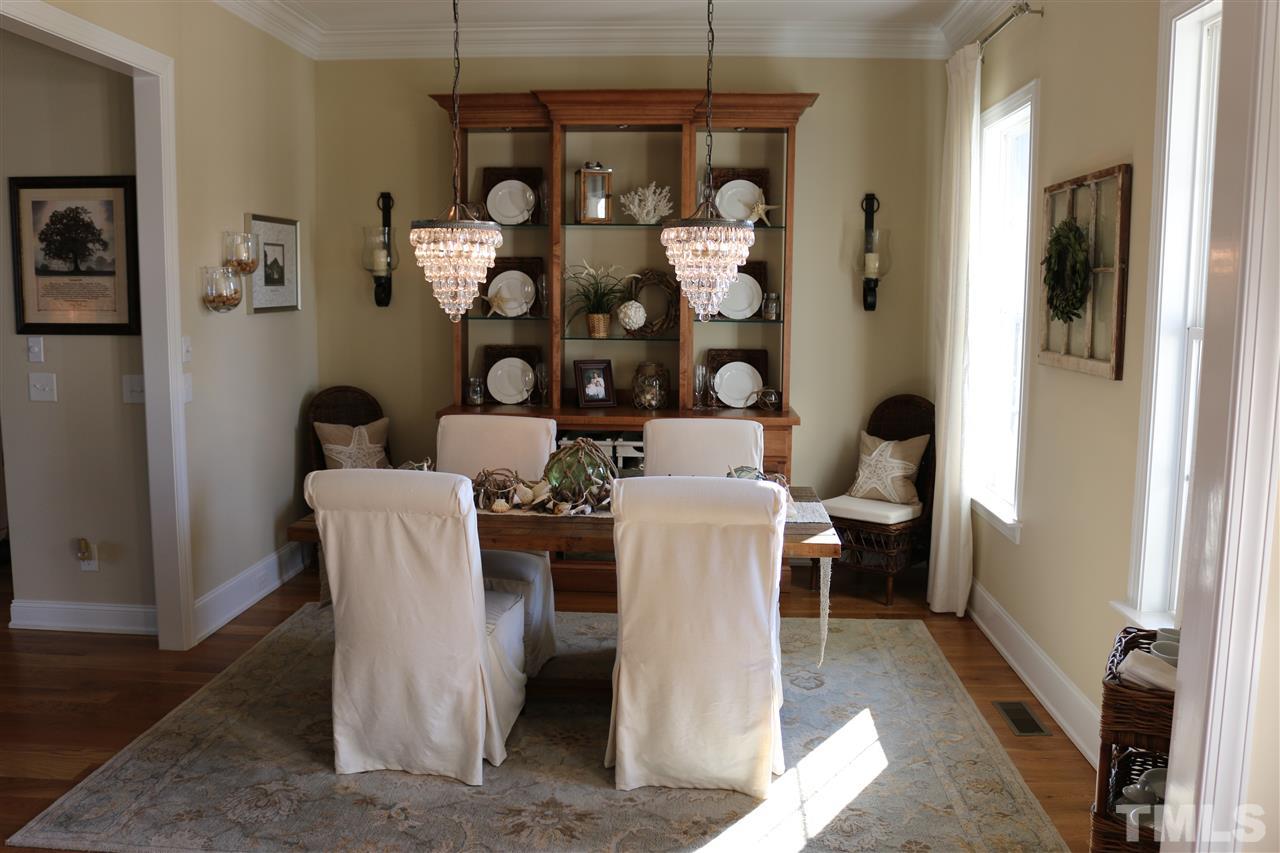 1108 Overlook Ridge Road Wake Forest, NC 27587 - Photo 3 of 14 a dining room with wooden floor and furniture