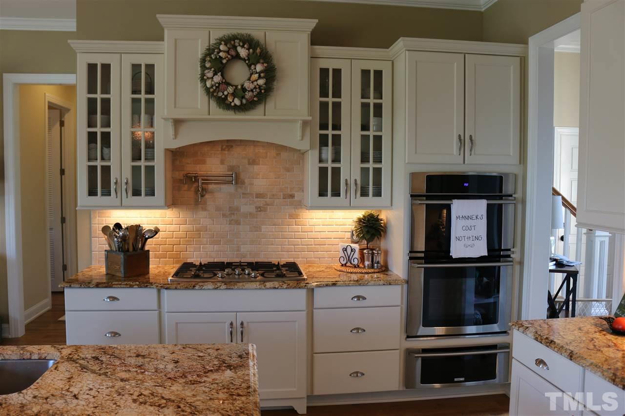 1108 Overlook Ridge Road Wake Forest, NC 27587 - Photo 7 of 14 a kitchen with stainless steel appliances granite countertop a stove and cabinets