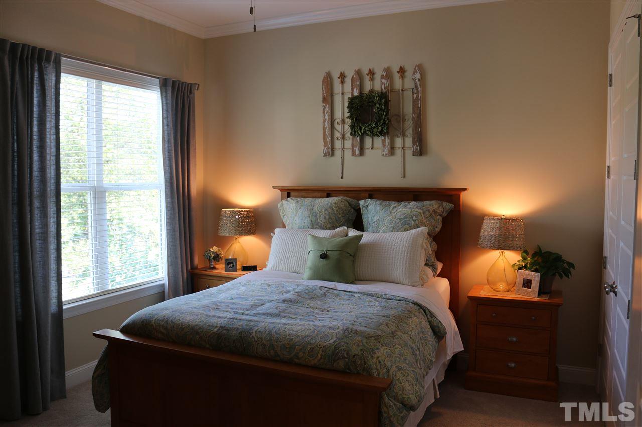 1108 Overlook Ridge Road Wake Forest, NC 27587 - Photo 9 of 14 a bed sitting in a bedroom next to a window