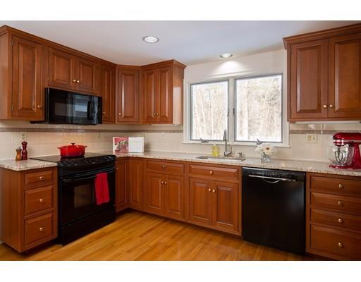 62 Woodridge Road Wayland, MA 01778 - Photo 3 of 11 a kitchen with stainless steel appliances granite countertop a stove a sink dishwasher and a microwave