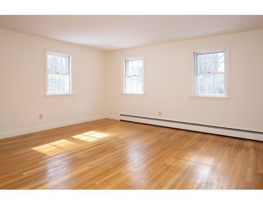 62 Woodridge Road Wayland, MA 01778 - Photo 7 of 11 a view of an empty room with wooden floor and a window