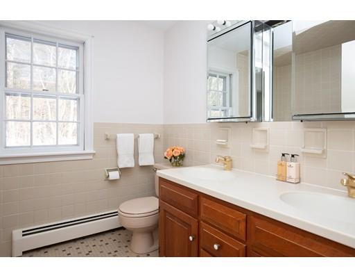 62 Woodridge Road Wayland, MA 01778 - Photo 8 of 11 a bathroom with a sink a toilet and a mirror