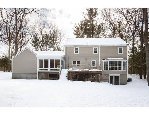 62 Woodridge Road Wayland, MA 01778 - Photo 10 of 11 a front view of a house with a yard covered with trees