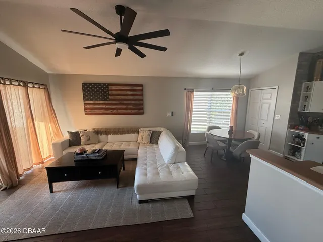 a living room with furniture a fireplace and a chandelier