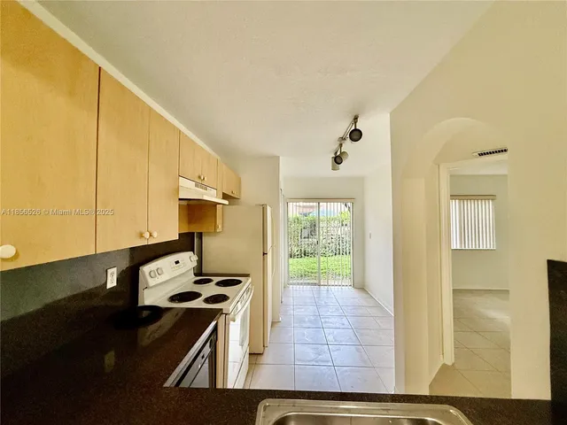 a kitchen with a sink and a stove top oven