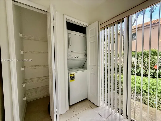 a yellow room with wooden floor and windows