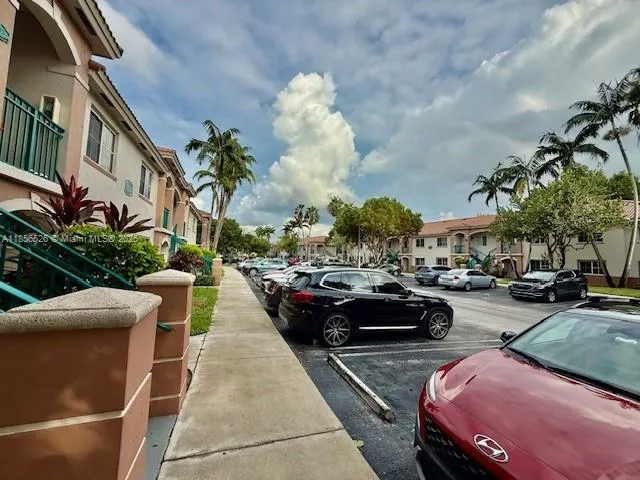 a view of a cars park in front of a building