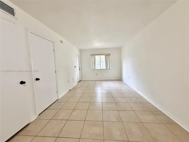 a view of an empty room and window