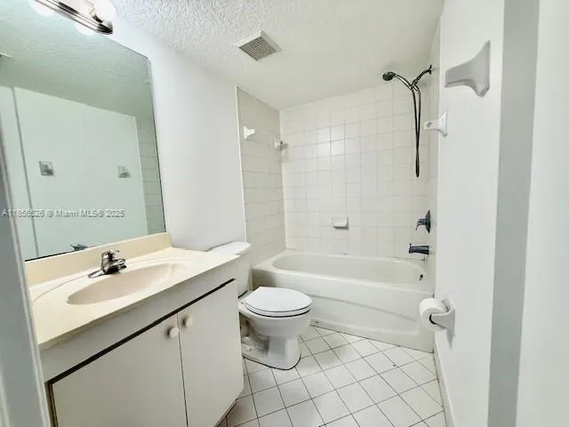 a bathroom with a sink a toilet a mirror a vanity and shower