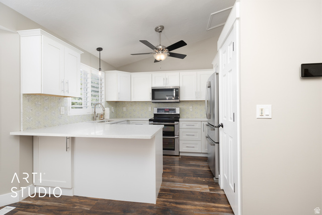 704 West Vahe Street Draper, UT 84020 - Photo 9 of 35 Contemporary kitchen featuring white cabinetry, light-toned backsplash, stainless steel appliances, wood-finish flooring, and a ceiling fan