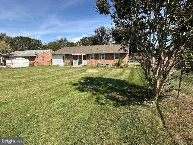 a kitchen with stainless steel appliances a stove sink refrigerator and cabinets