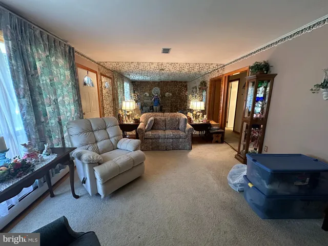 a living room with furniture a chandelier and a flat screen tv