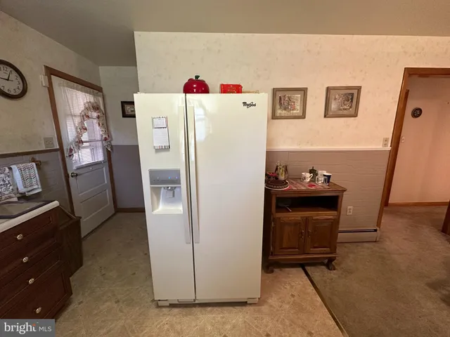 a living room with furniture and a large mirror
