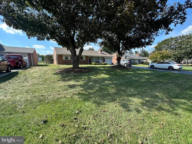 a view of yard with swimming pool and green space