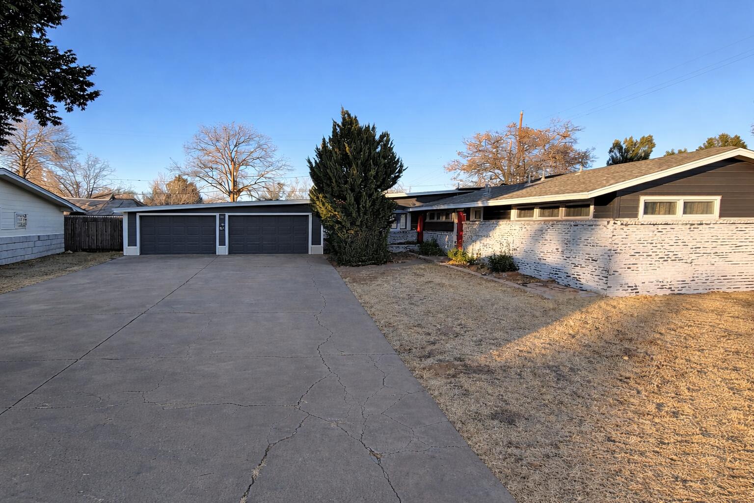 a view of a house with yard and sitting area