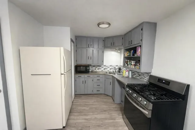 a kitchen with a sink stove and refrigerator